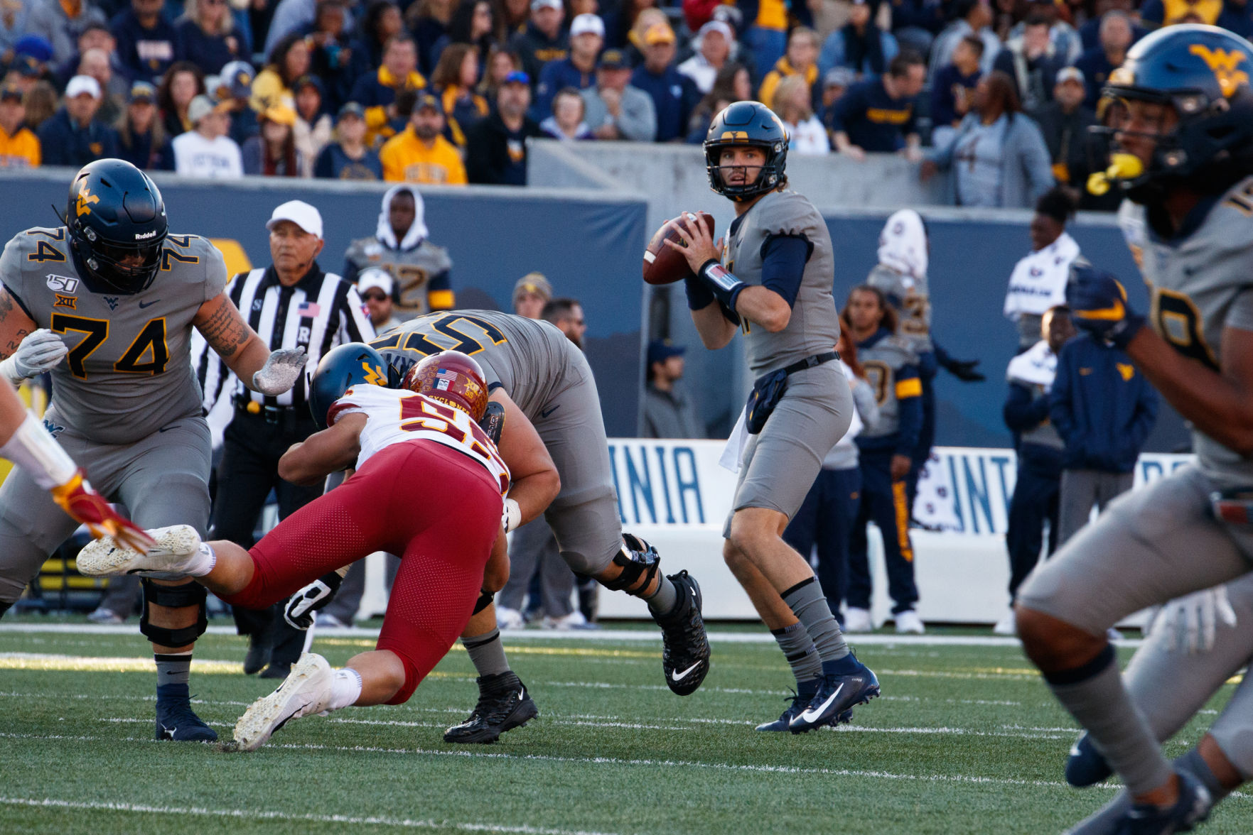 October 12, 2019: West Virginia's Jack Allison surveys the field. Allison replaced the injured Austin Kendall at quarterback during the first quarter.